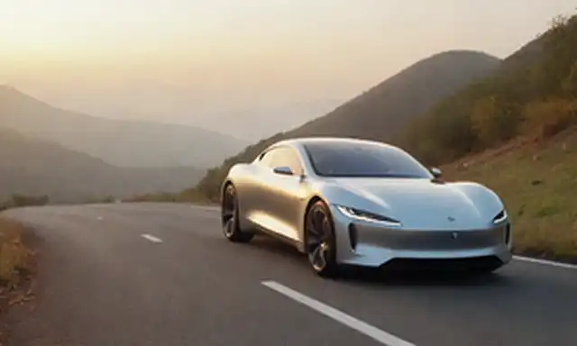 Un coche eléctrico elegante en una carretera de montaña de viento