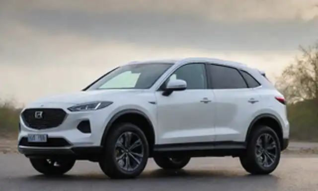 Un SUV elegante, compacto y de lujo con una audacia rejilla, faros afilados, y un techo inclinado; una placa de propulsión híbrida en el panel lateral; una firma de iluminación LED futurista en la parte trasera; un diseño sofisticado y aerodinámico; un trabajo de pintura premium en un acabado metálico o perla; un esquema de color exterior con acentos contrastantes; un estilo corporal esculpido 3D
